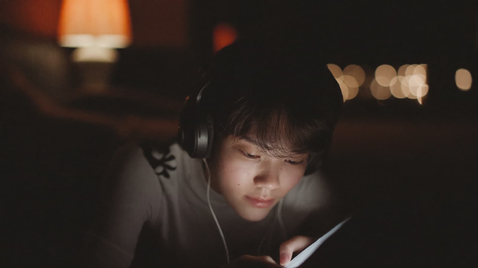 Person reviewing notes on their phone at night, lit by the screen